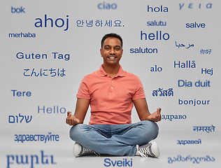 Image showing happy indian man over words in foreign languages