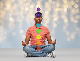 Image showing happy indian man meditating in lotus yoga pose