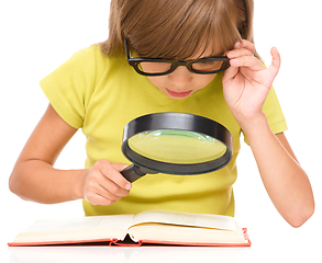 Image showing Little girl is reading book