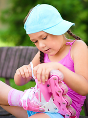 Image showing Little girl is wearing roller-blades