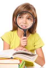 Image showing Little girl is reading book