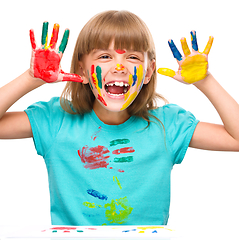 Image showing Portrait of a cute girl playing with paints