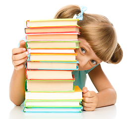 Image showing Little girl plays with book