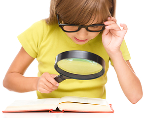 Image showing Little girl is reading book