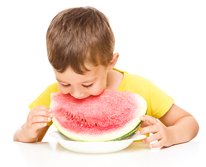 Image showing Little boy is eating watermelon