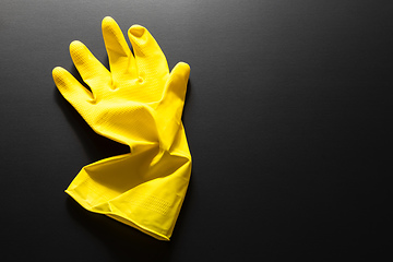 Image showing yellow rubber glove isolated on black background
