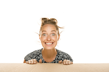 Image showing Young woman opening the biggest postal package isolated on white