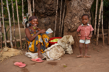 Image showing Malagasy woman with child selling fruits, Nosy Be port, Madagasc