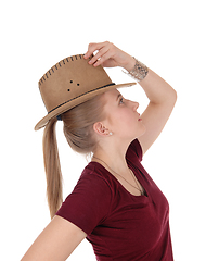 Image showing Woman posing with brown cowboy hat