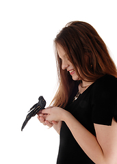 Image showing Woman holding a fake bird in her hands
