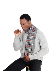 Image showing Coughing young man sitting with scarf