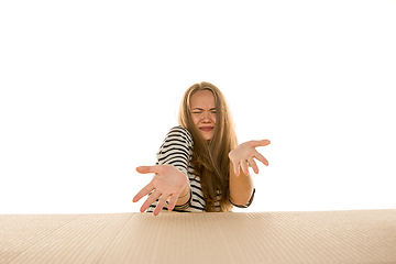 Image showing Young woman opening the biggest postal package isolated on white