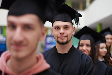 Image showing Group of diverse international graduating students celebrating