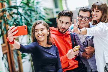 Image showing Group of multiethnic teenagers taking a selfie in school