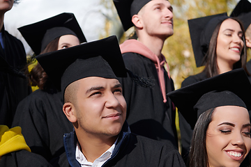 Image showing Group of diverse international graduating students celebrating