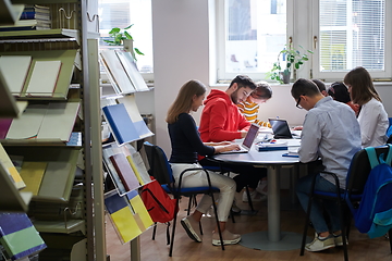 Image showing students group working on school project together on tablet computer at modern university