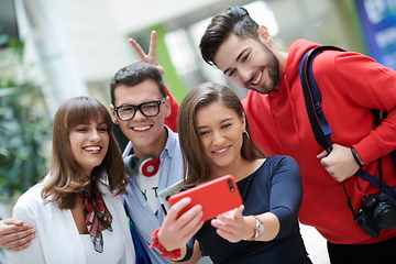 Image showing Group of multiethnic teenagers taking a selfie in school