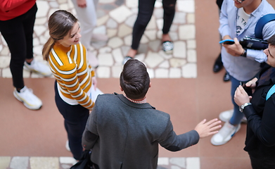 Image showing students communication with professor in school corridor