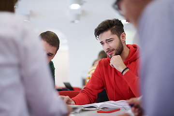 Image showing students group working on school project together on tablet computer at modern university