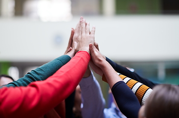 Image showing students together in problem, arm in the air