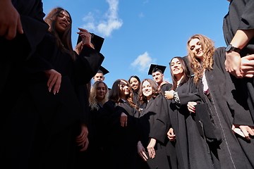 Image showing Group of diverse international graduating students celebrating