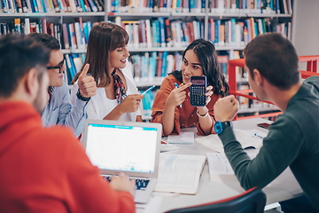 Image showing students group working on school project together on tablet computer at modern university