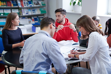 Image showing students group working on school project together on tablet computer at modern university