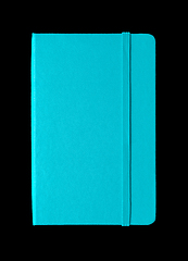 Image showing Aqua blue closed notebook isolated on black