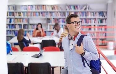 Image showing the student uses a notebook, latop and a school library