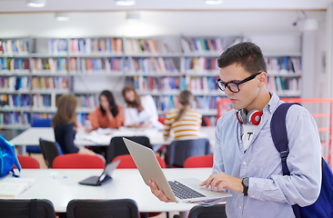 Image showing the student uses a notebook, latop and a school library