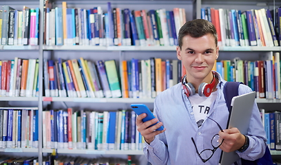 Image showing the student uses a notebook, latop and a school library