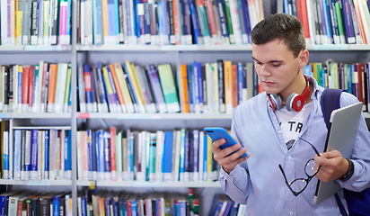 Image showing the student uses a notebook, latop and a school library