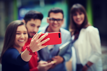 Image showing Group of multiethnic teenagers taking a selfie in school