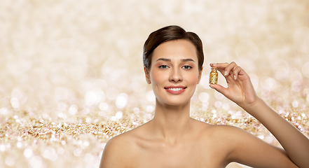 Image showing beautiful young woman with gold facial mask