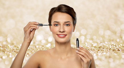 Image showing beautiful woman applying mascara