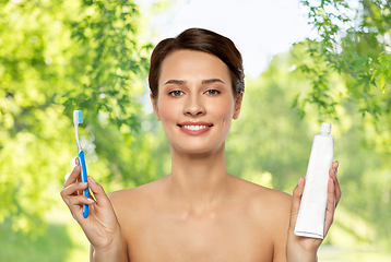 Image showing smiling woman with toothbrush cleaning teeth