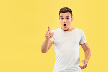 Image showing Caucasian young man\'s half-length portrait on yellow background