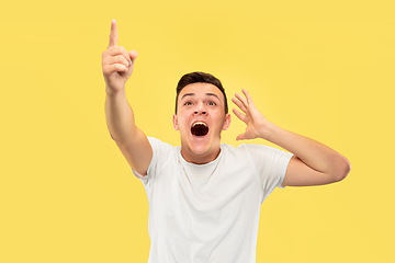 Image showing Caucasian young man\'s half-length portrait on yellow background