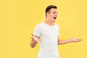 Image showing Caucasian young man\'s half-length portrait on yellow background