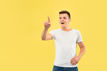 Image showing Caucasian young man\'s half-length portrait on yellow background