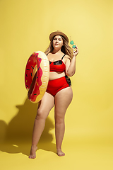 Image showing Young caucasian plus size female model\'s preparing for beach resort