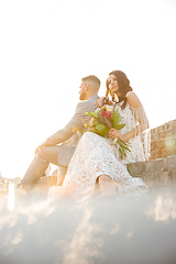 Image showing Caucasian romantic young couple celebrating their marriage in city