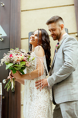 Image showing Caucasian romantic young couple celebrating their marriage in city