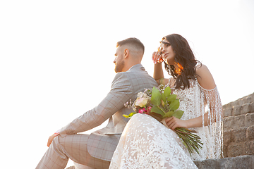 Image showing Caucasian romantic young couple celebrating their marriage in city