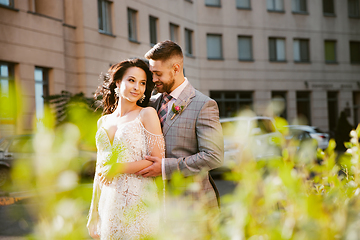 Image showing Caucasian romantic young couple celebrating their marriage in city