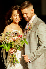 Image showing Caucasian romantic young couple celebrating their marriage in city