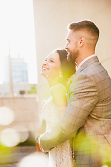 Image showing Caucasian romantic young couple celebrating their marriage in city