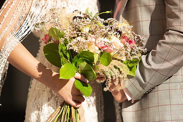 Image showing Caucasian romantic young couple celebrating their marriage in city