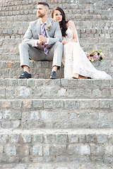 Image showing Caucasian romantic young couple celebrating their marriage in city