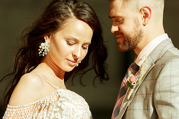 Image showing Caucasian romantic young couple celebrating their marriage in city